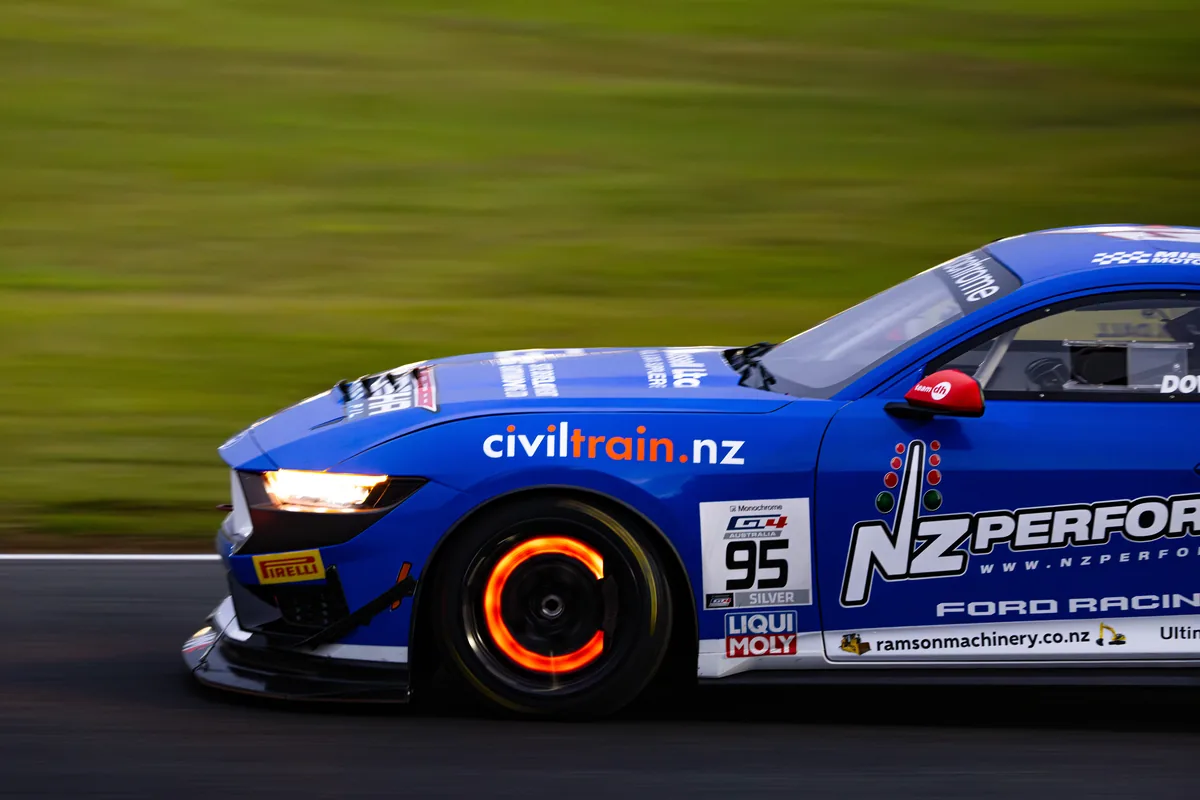 The #95 Ford Mustang GT4 at speed under lights in the Queensland Raceway night race