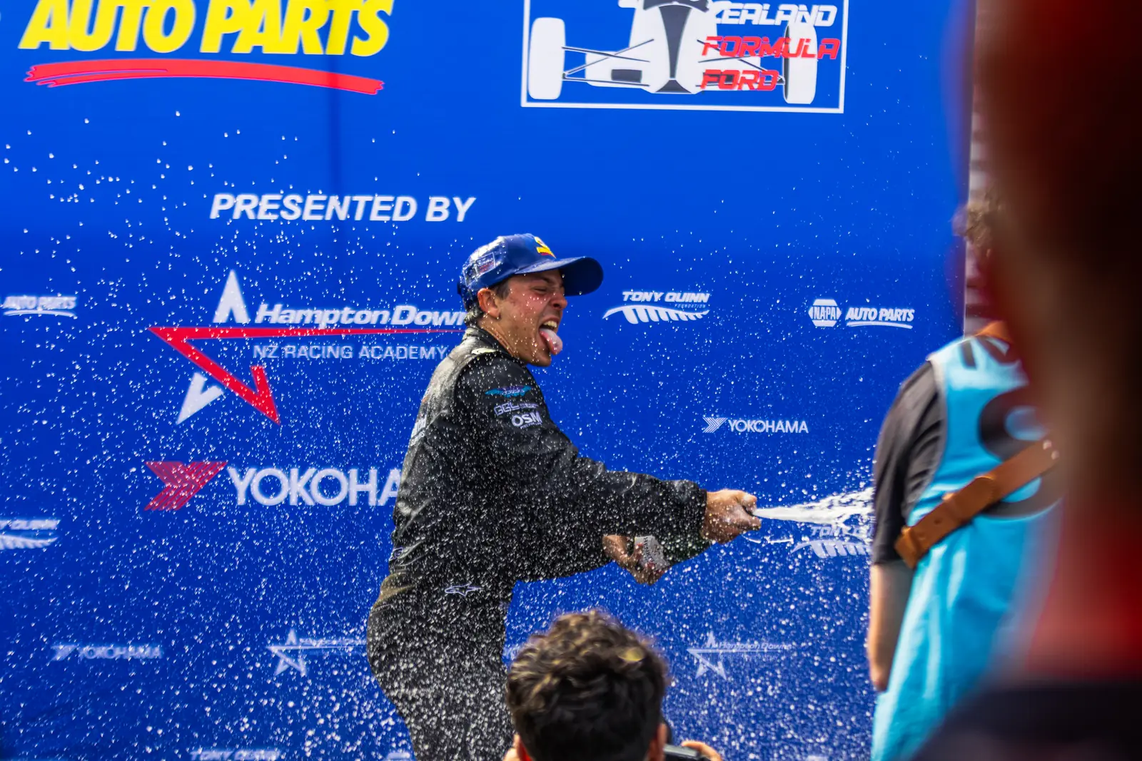 Blake Dowdall sprays champagne in celebration at Manfeild.