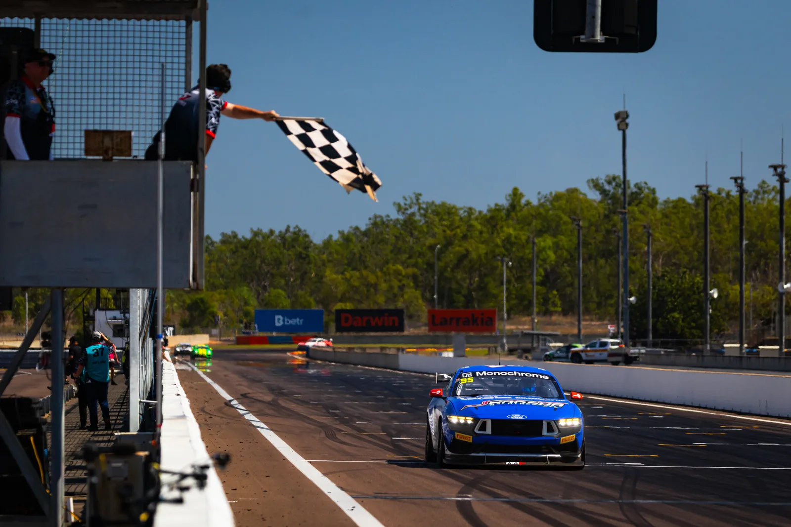 The chequered flag falls as Blake Dowdall's Ford Mustang GT4 crosses the line at Hidden Valley
