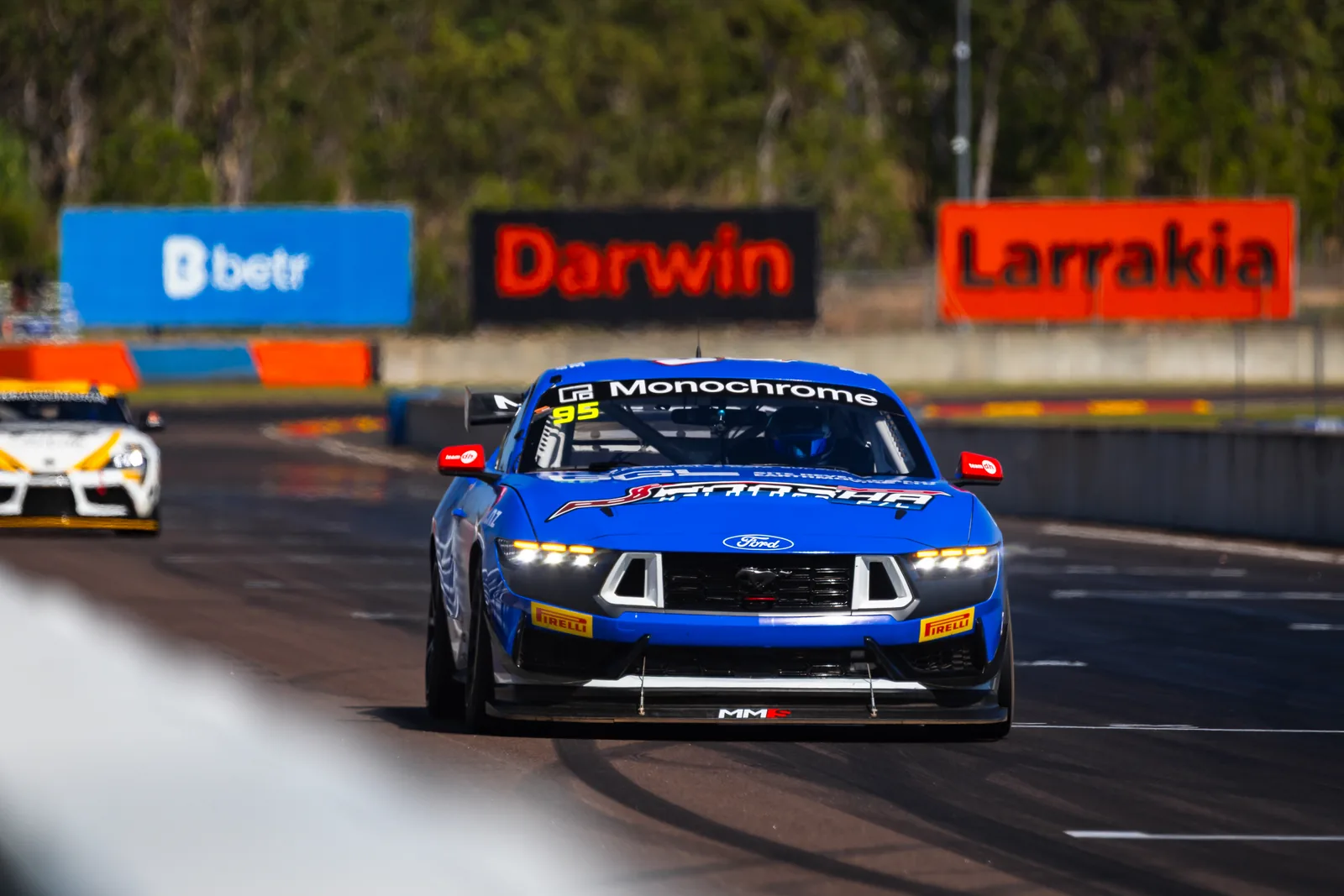 Blake Dowdall's Ford Mustang GT4 battles past the Darwin trackside signage