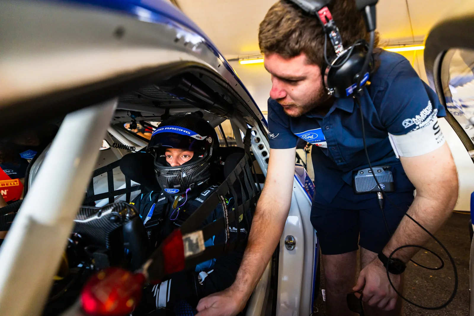 A Miedecke Motorsport engineer works with Blake Dowdall in the #95 Ford Mustang GT4 cockpit