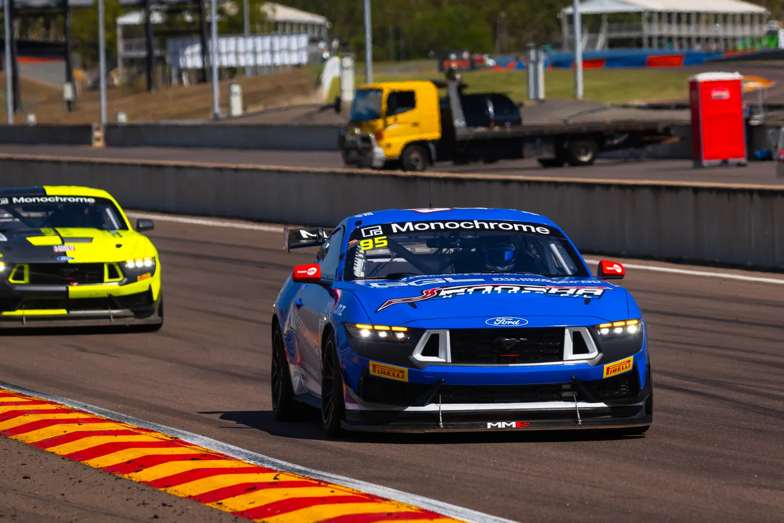 The #95 Ford Mustang GT4 leads a group of GT4 cars at Hidden Valley