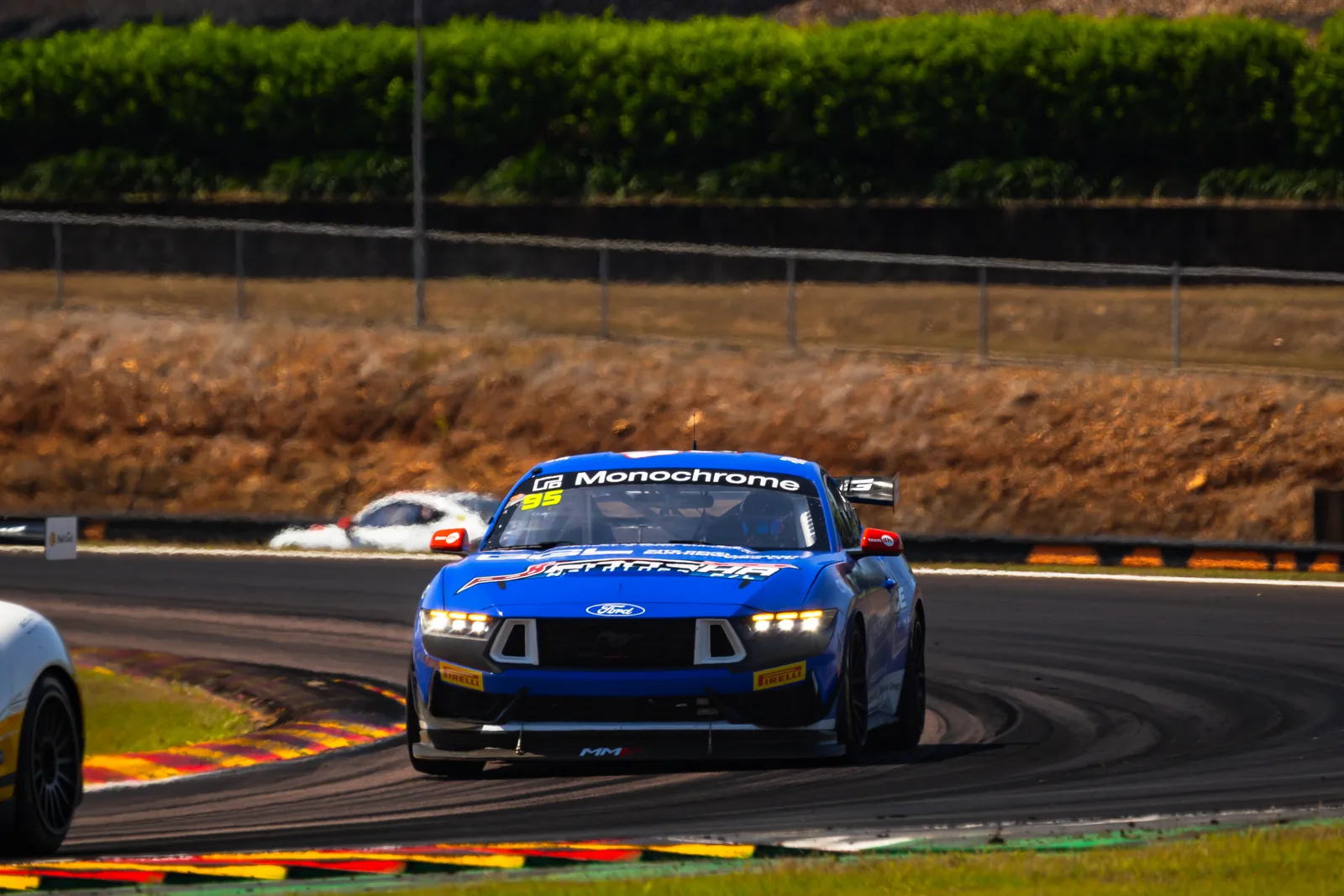 The #95 Ford Mustang GT4 through a corner at Hidden Valley, Darwin