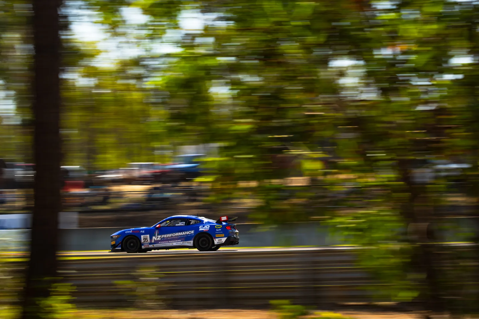 Blake Dowdall's Ford Mustang GT4 at speed through the trees at Hidden Valley