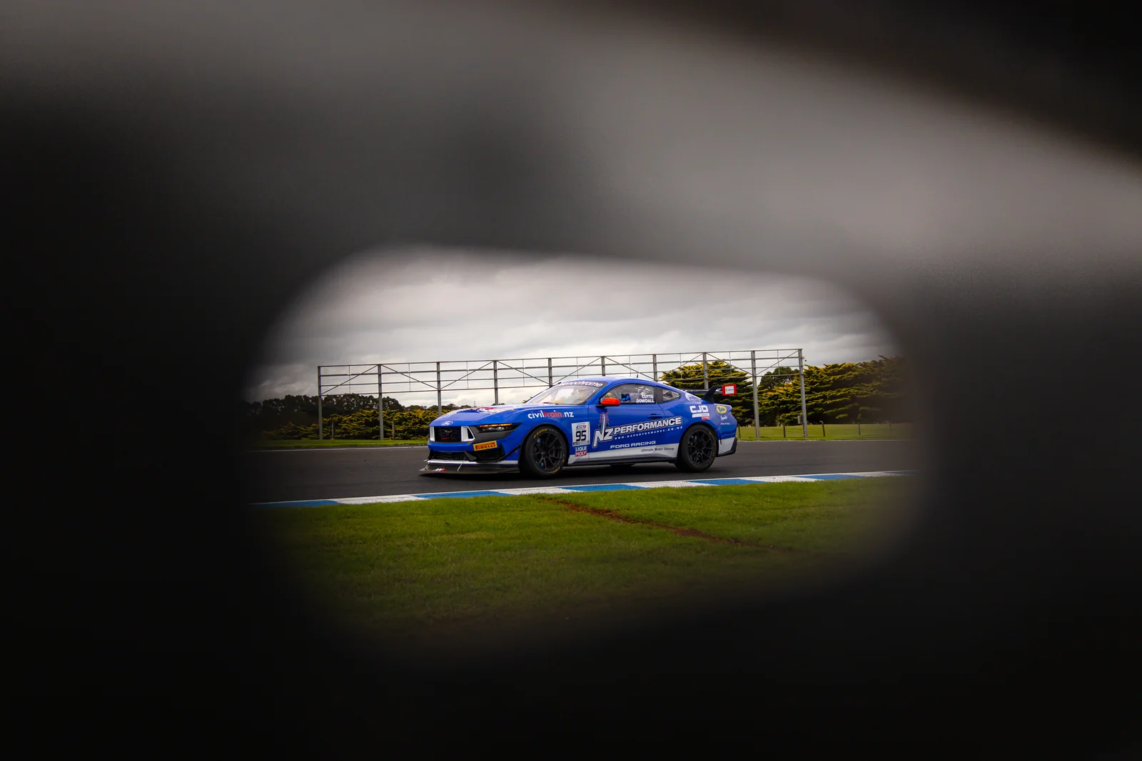 Blake Dowdall's GT4 Ford Mustang in a low-light studio-style frame