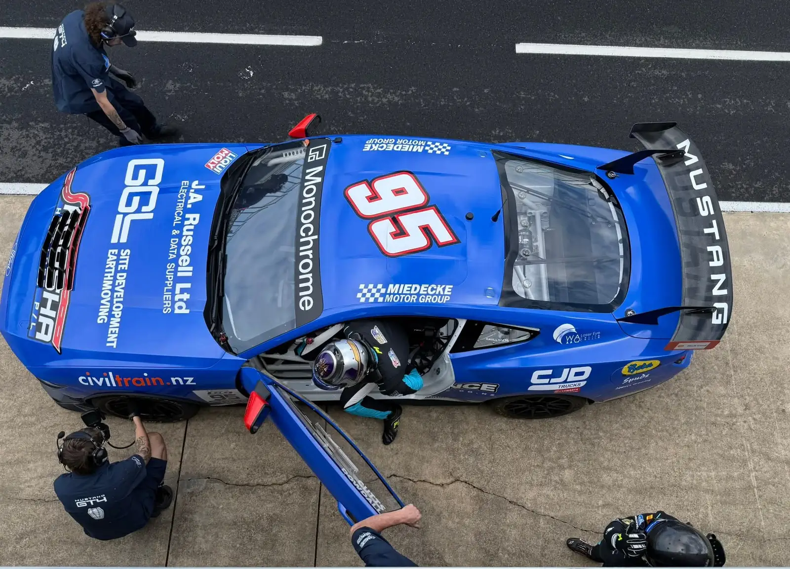 Overhead view of Blake Dowdall's Ford Mustang GT4 and crew in pit lane