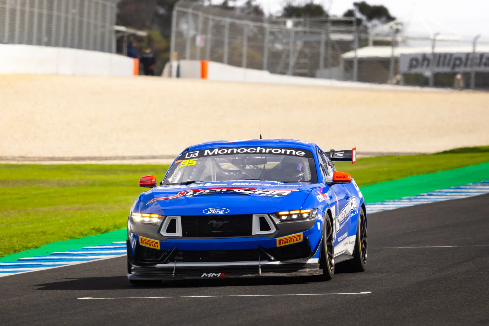 The #95 Ford Mustang GT4 attacks a kerb at Phillip Island