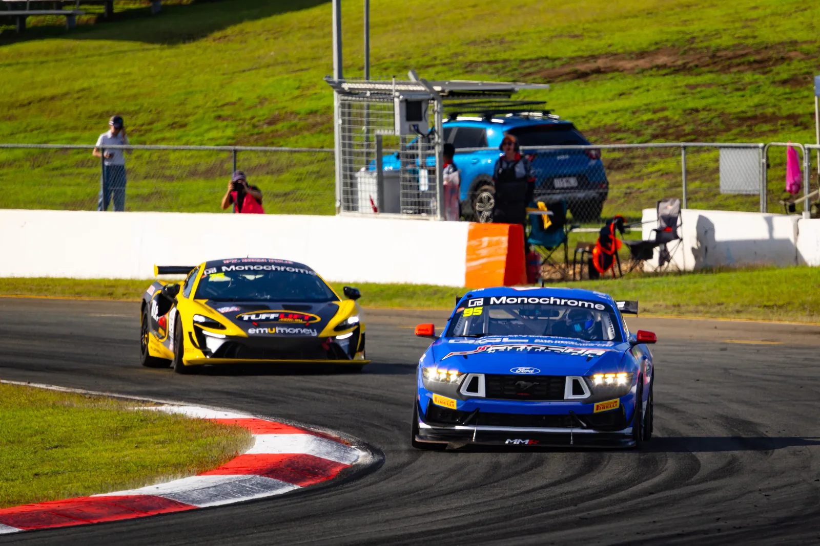 The #95 Ford Mustang GT4 chases a rival through the corners in practice at Queensland Raceway