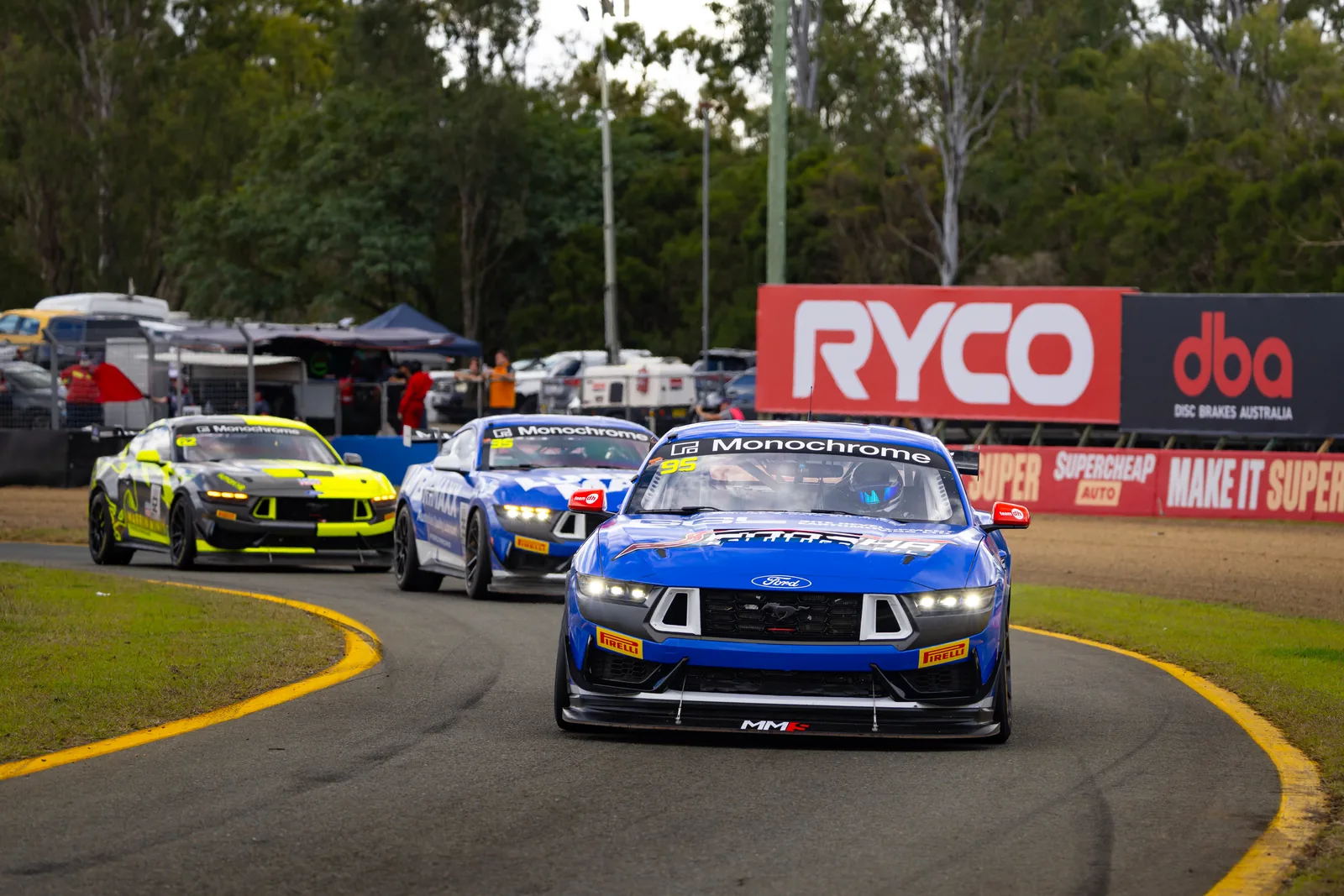 The #95 Ford Mustang GT4 leads a group of GT4 cars at Queensland Raceway