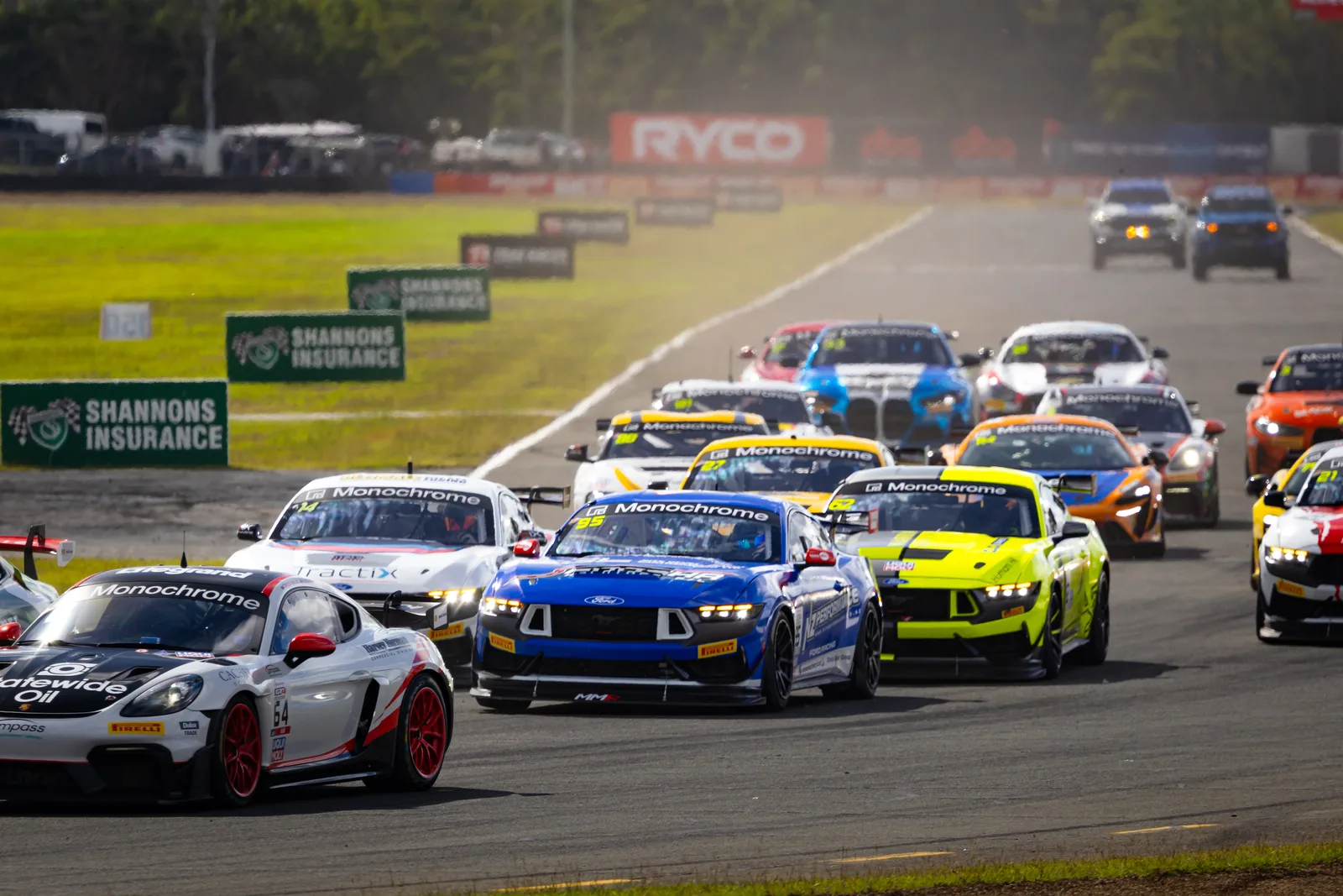 The GT4 Australia field streams into Turn 1 at the start of Race 2 at Queensland Raceway