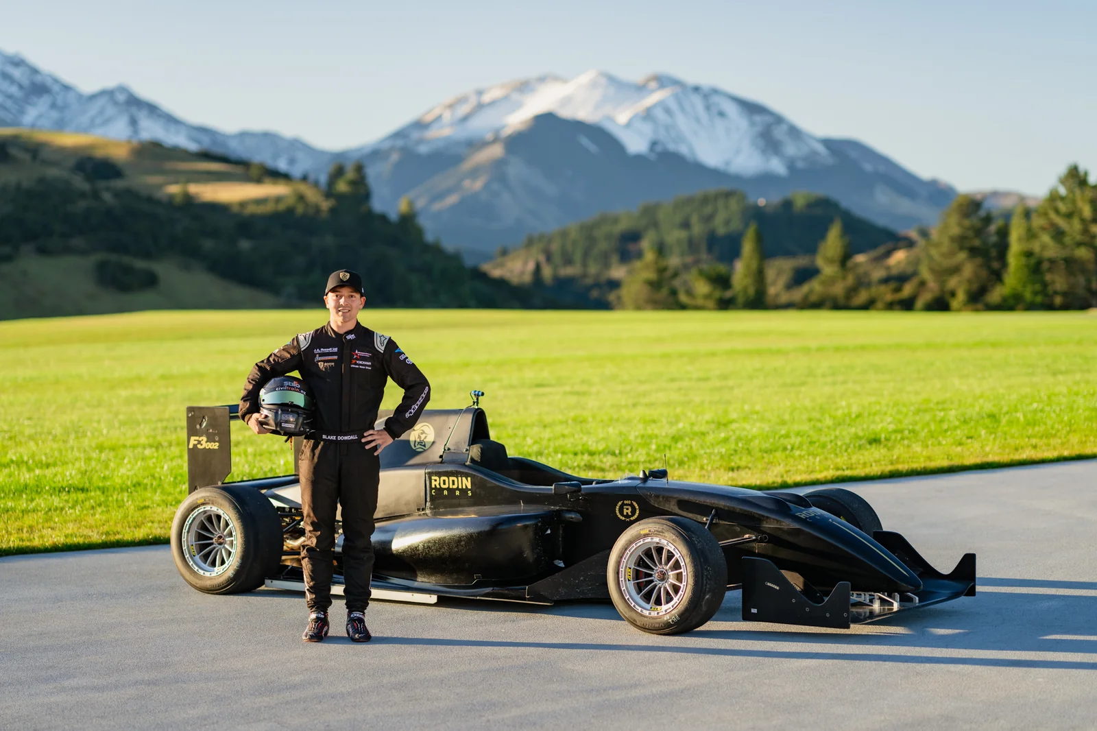 Blake Dowdall with a Rodin Cars single-seater against the New Zealand mountains